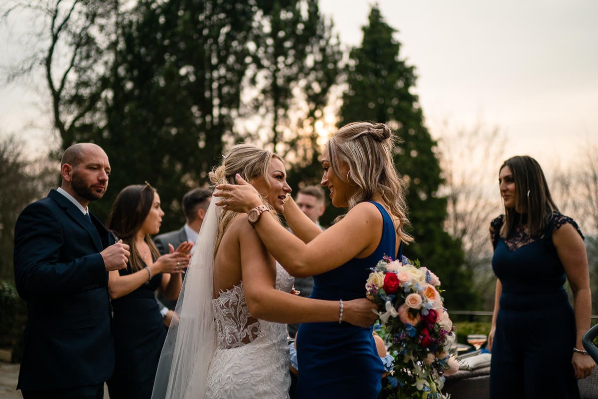 bride being hugged at mitton hall wedding