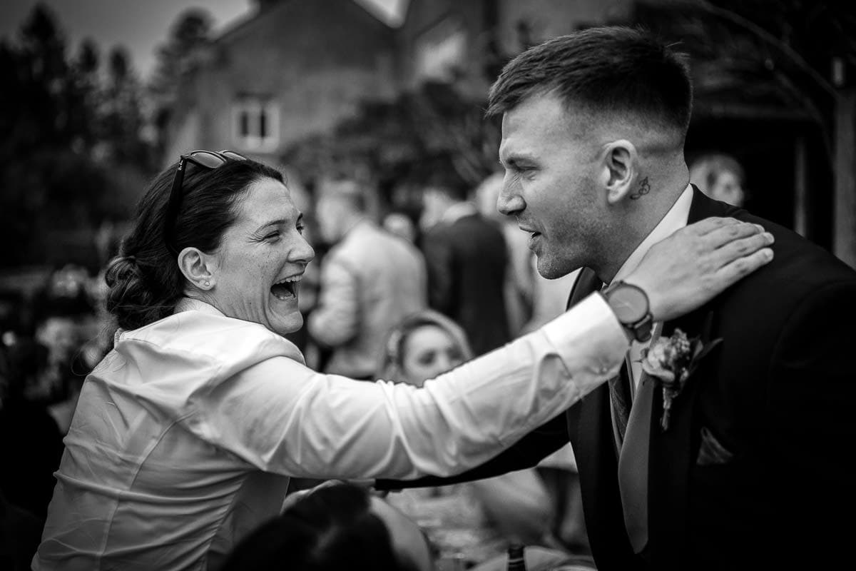 groom being hugged at mitton hall wedding