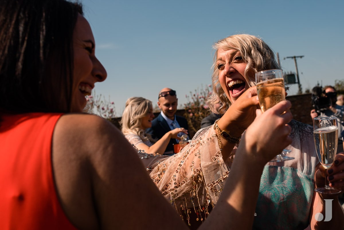 laughing wedding guests