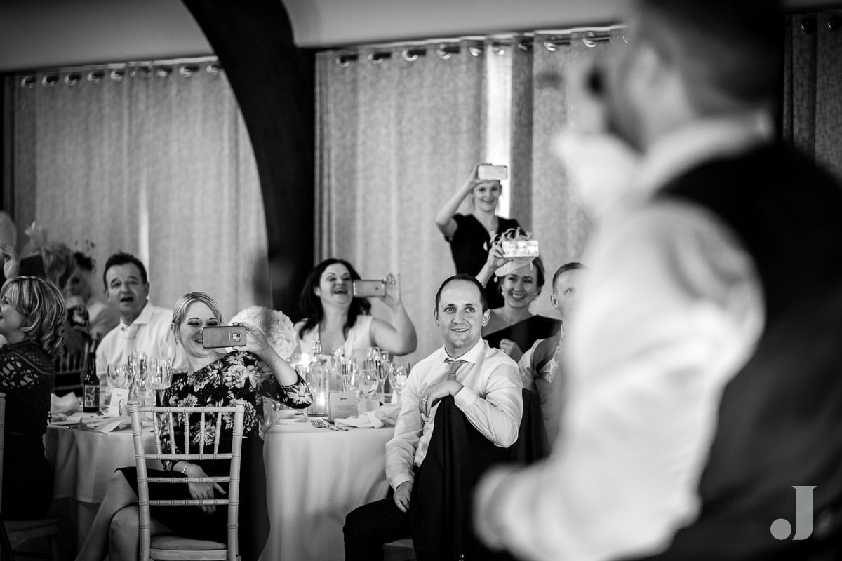 guests watching the groom speech