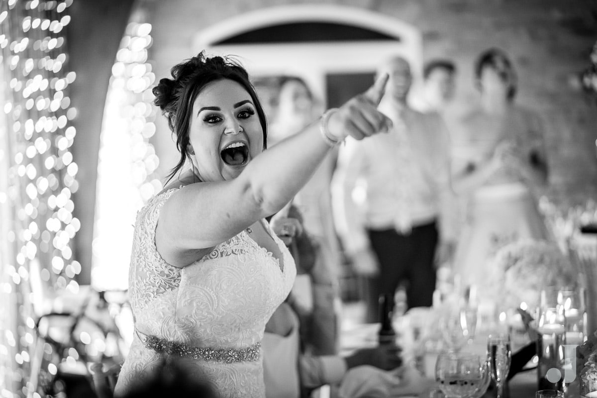 bride pointing at funny speech