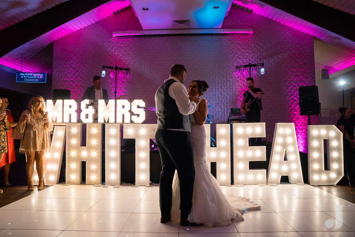 first dance in front of light up letters