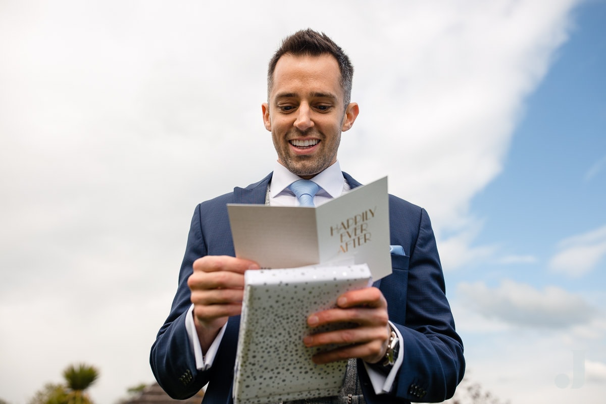 groom reading wedding card